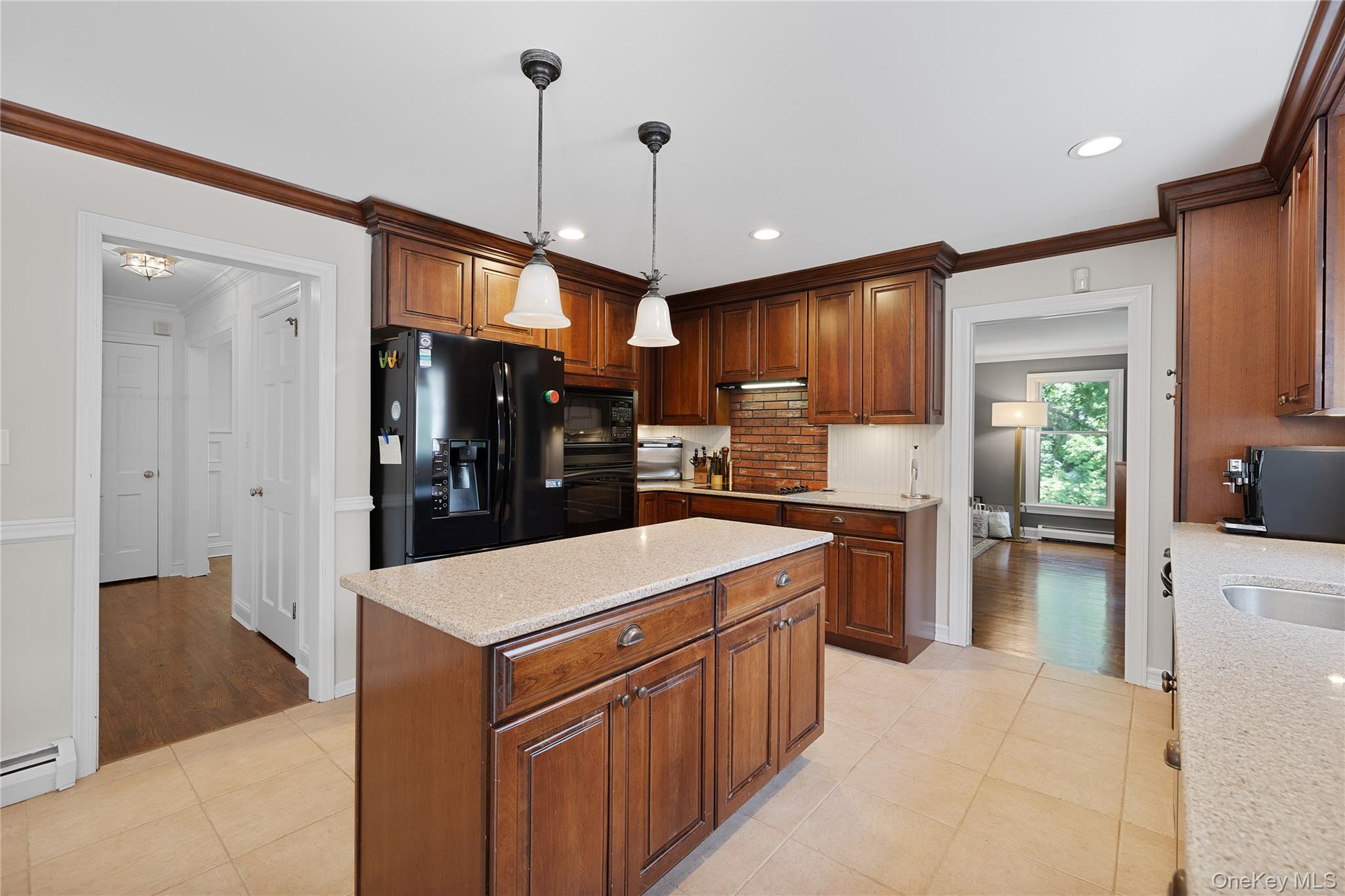 9 Three Sisters Road St. James, NY 11780 - Photo 4 of 36 Kitchen featuring extensive wood cabinetry, a central island with a light-toned countertop, and recessed lighting