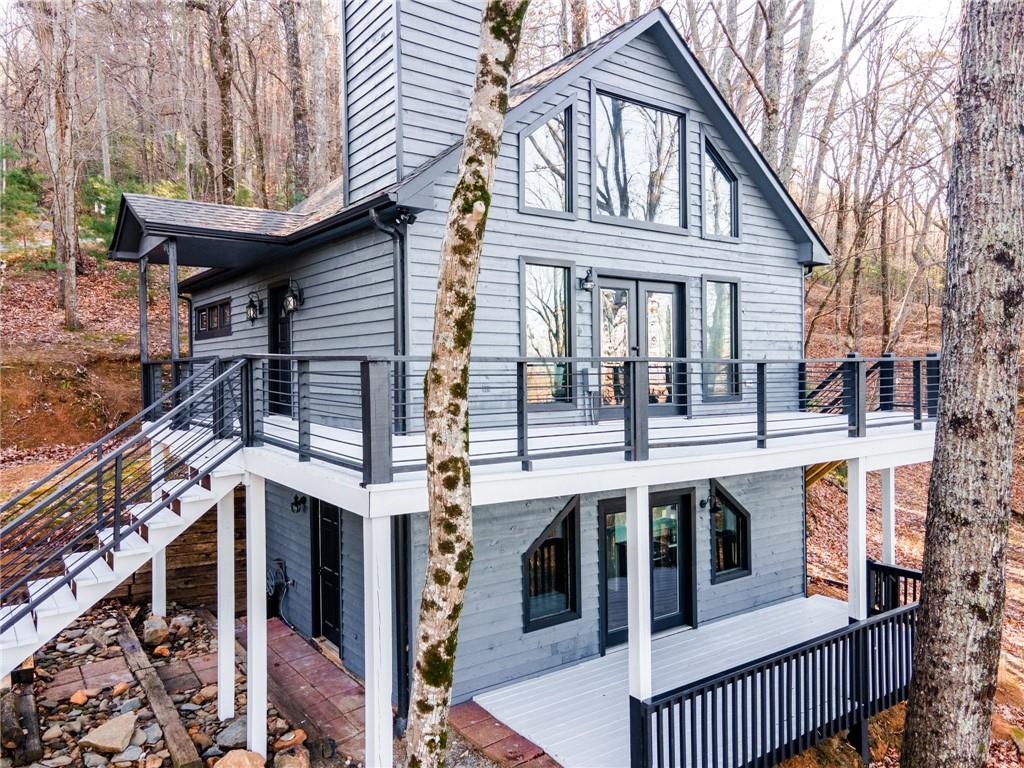 a view of a house with a wooden fence