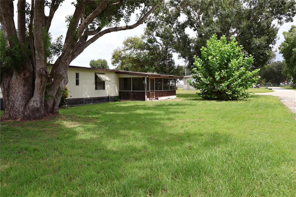 a backyard of a house with yard and outdoor seating