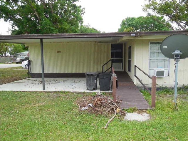 a backyard of a house with table and chairs