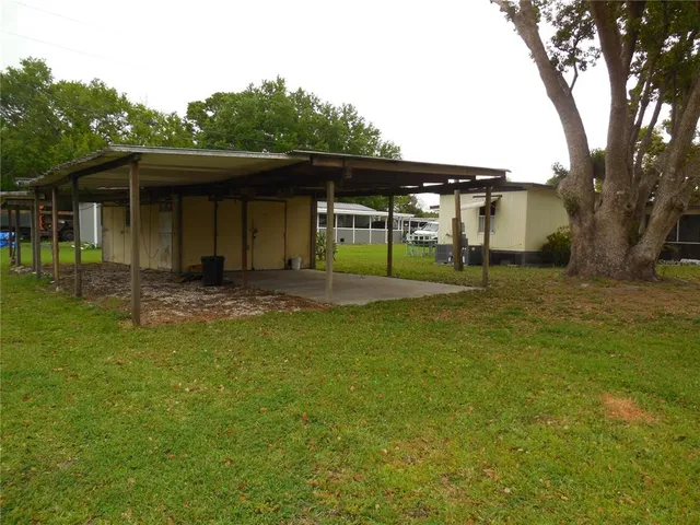 a backyard of a house with barbeque oven