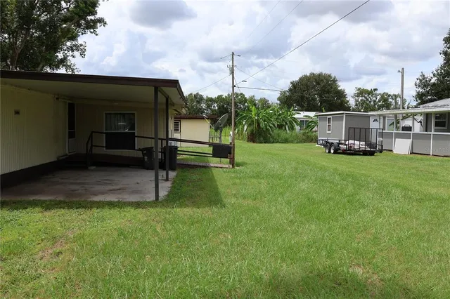 a view of a house with backyard sitting area and garden