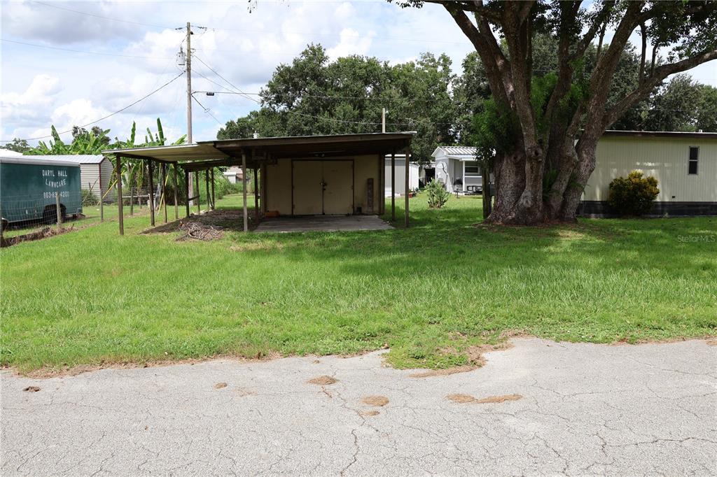 1007 Sparrow Road Wauchula, FL 33873 - Photo 7 of 42 a view of a patio with table and chairs potted plants and large tree