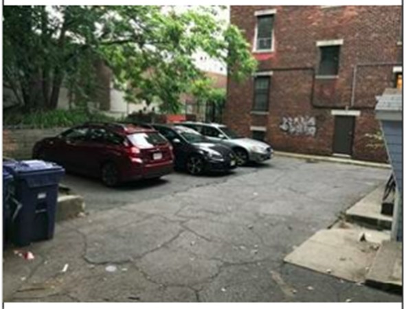 a cars parked in front of a brick building