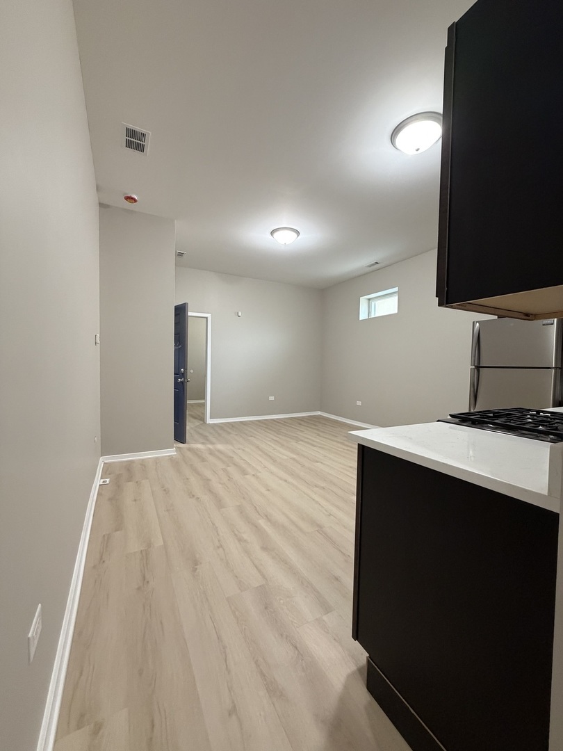 22 North Pulaski Road, Unit 1R Chicago, IL 60624 - Photo 11 of 22 a view of kitchen with wooden floor