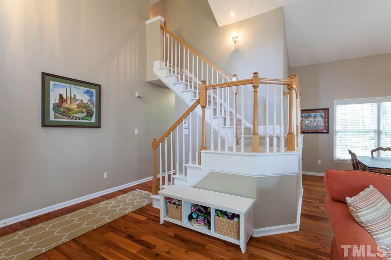 12308 Hartwick Court Raleigh, NC 27613 - Photo 12 of 20 a living room with stairs and a wooden floor
