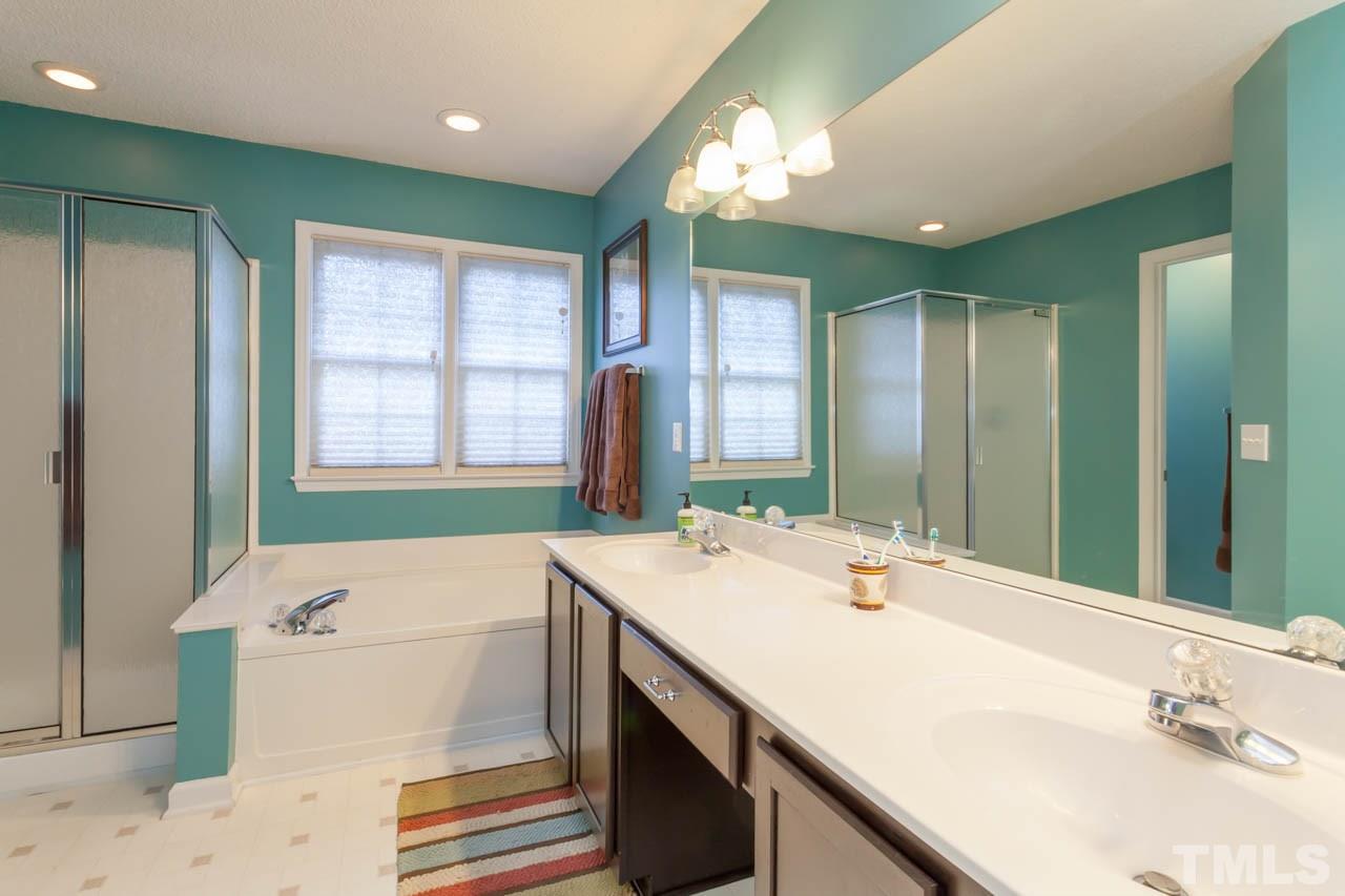 12308 Hartwick Court Raleigh, NC 27613 - Photo 14 of 20 a bathroom with a sink and a large mirror