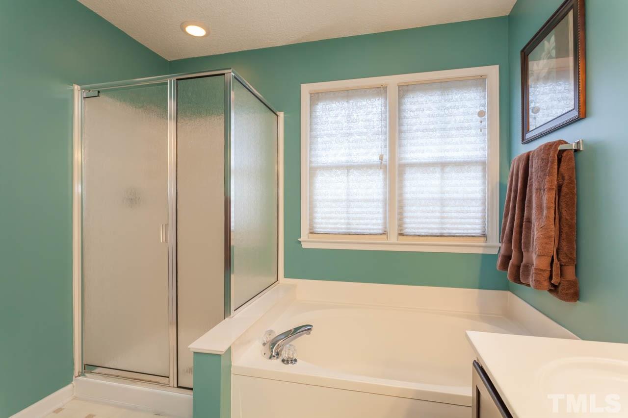 12308 Hartwick Court Raleigh, NC 27613 - Photo 15 of 20 a bathroom with a bathtub and a shower
