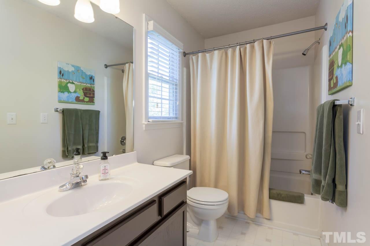 12308 Hartwick Court Raleigh, NC 27613 - Photo 18 of 20 a bathroom with a sink a toilet and shower