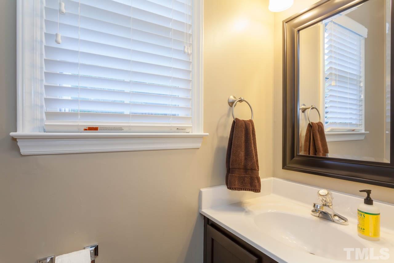 12308 Hartwick Court Raleigh, NC 27613 - Photo 19 of 20 a bathroom with a sink and a mirror