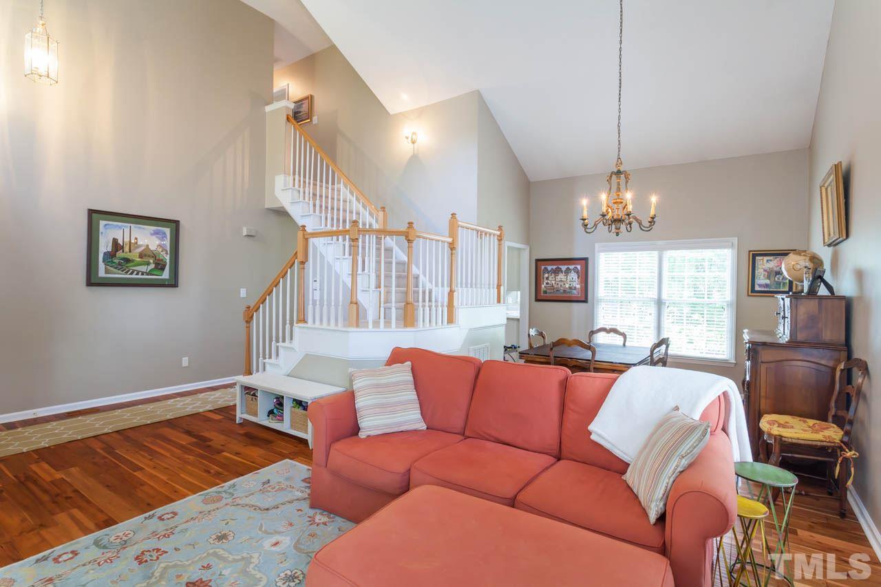12308 Hartwick Court Raleigh, NC 27613 - Photo 4 of 20 a living room with furniture and a chandelier