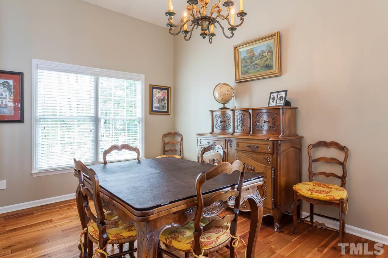 12308 Hartwick Court Raleigh, NC 27613 - Photo 9 of 20 a view of a dining room with furniture window and wooden floor