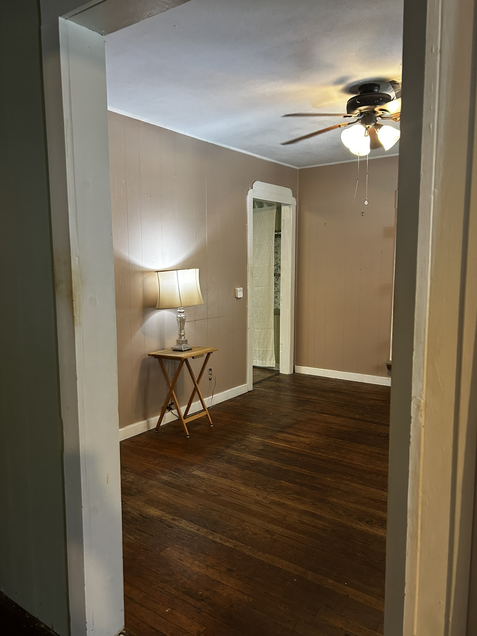 5702 Duval Street Austin, TX 78752 - Photo 26 of 31 Room featuring wood-finish flooring, neutral wall tones, and white trim