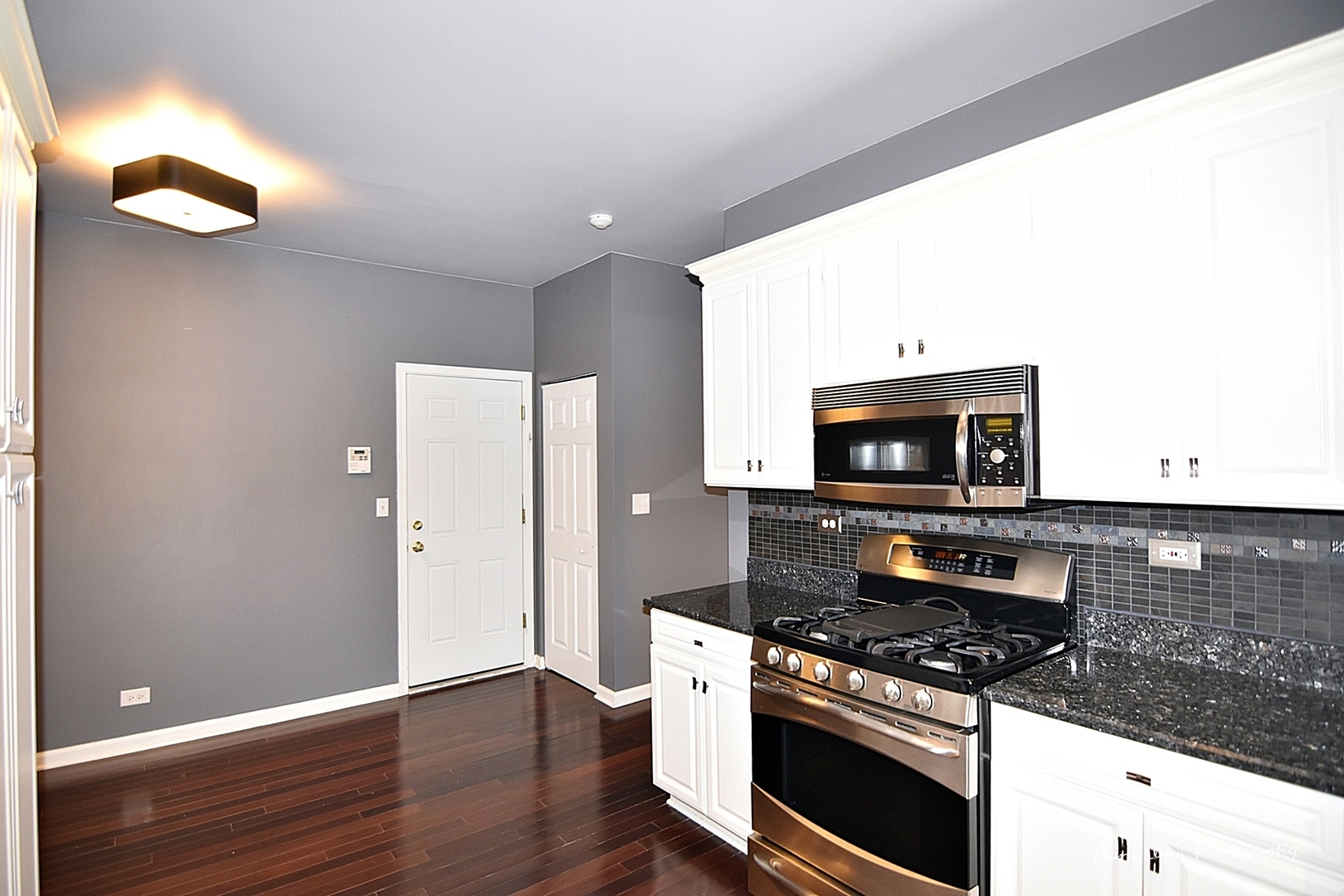 385 Ridge Road North Aurora, IL 60542 - Photo 5 of 30 a kitchen with a stove and a microwave