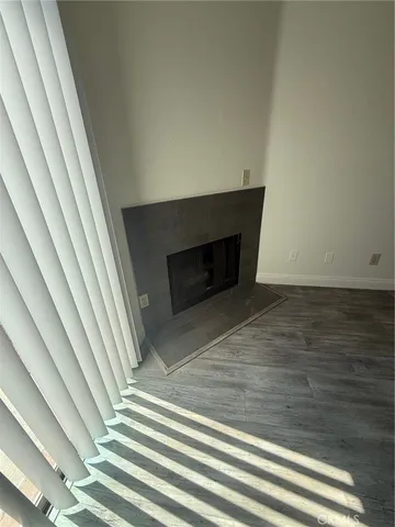a view of a livingroom with wooden floor and staircase