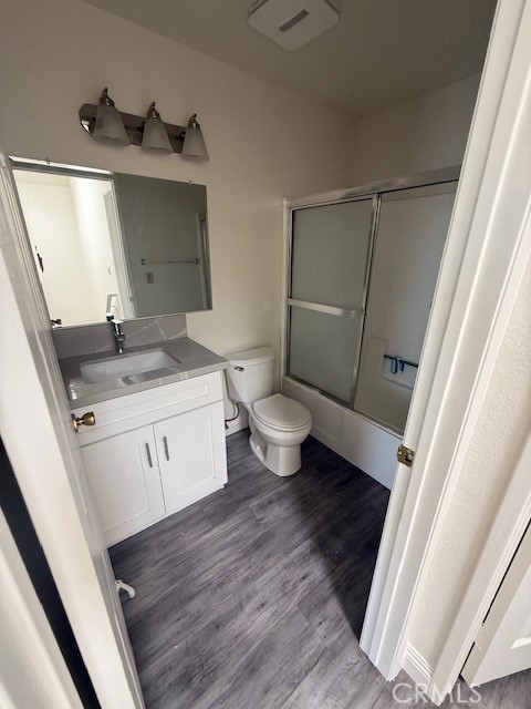 15642 Pasadena Avenue Tustin, CA 92780 - Photo 8 of 10 a bathroom with a granite countertop sink toilet and mirror