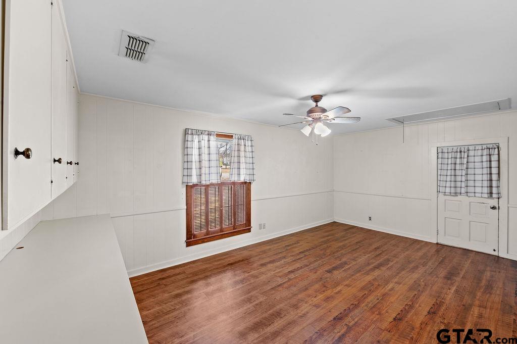 610 Tamy Street Quitman, TX 75783 - Photo 14 of 29 a view of empty room with wooden floor and fan