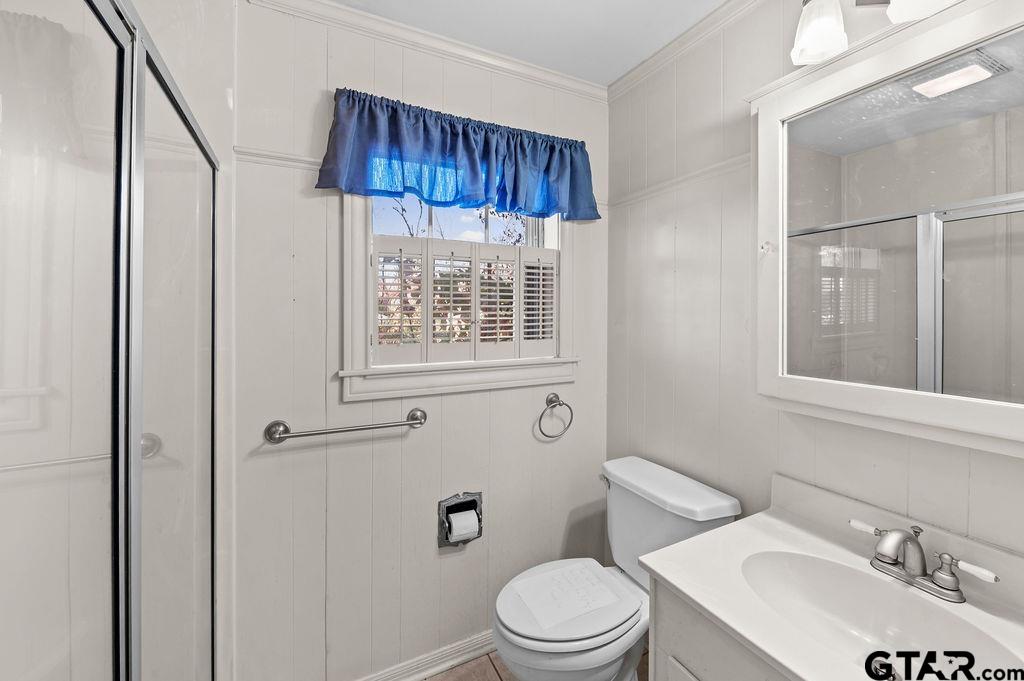 610 Tamy Street Quitman, TX 75783 - Photo 18 of 29 a white toilet sitting next to a bathroom sink