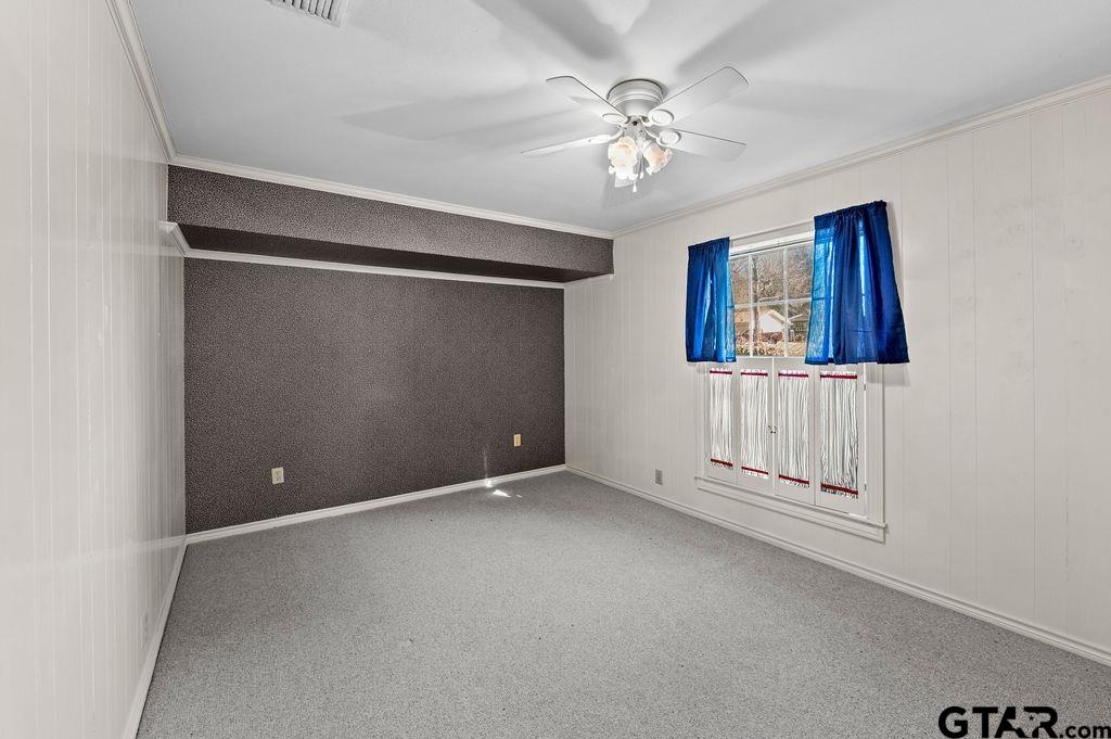 610 Tamy Street Quitman, TX 75783 - Photo 22 of 29 en empty room with windows and ceiling fan