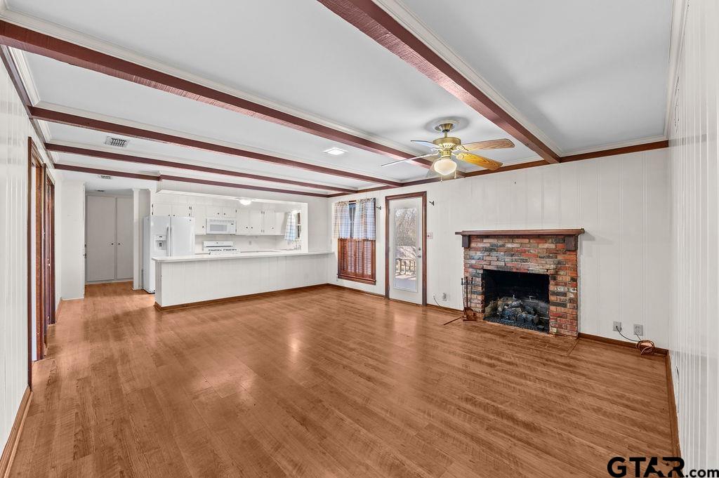610 Tamy Street Quitman, TX 75783 - Photo 3 of 29 a view of an empty room with a fireplace and a window