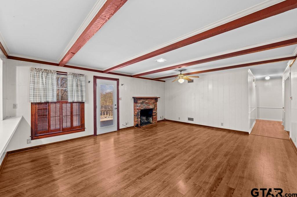 610 Tamy Street Quitman, TX 75783 - Photo 7 of 29 a view of an empty room with wooden floor and a window