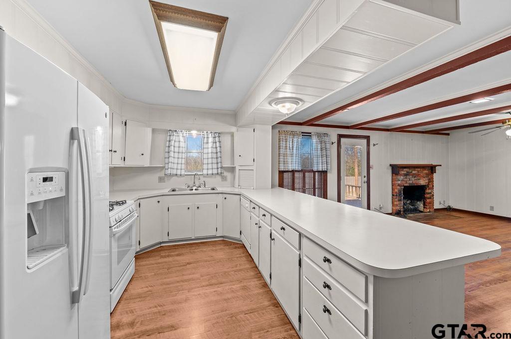610 Tamy Street Quitman, TX 75783 - Photo 10 of 29 a large white kitchen with a window and refrigerator