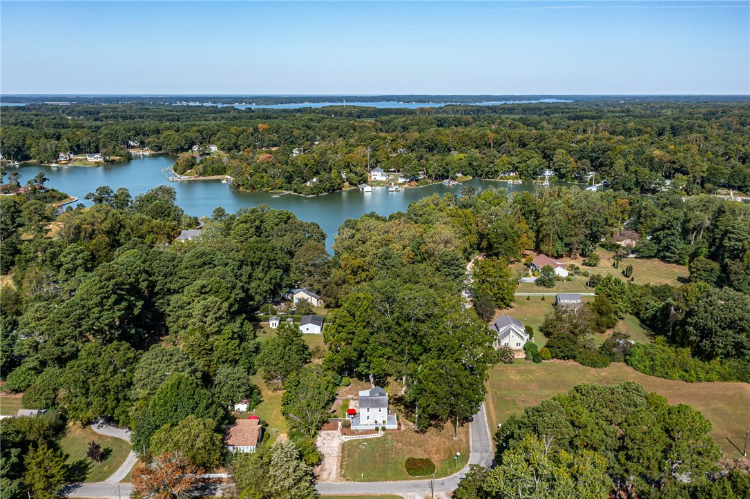 97 Virginia Road Irvington, VA 22480 - Photo 32 of 39 Aerial view of property and surrounding area with a nearby body of water and a heavily wooded area