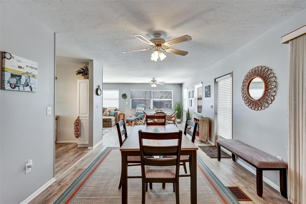 10315 Cortez Road West, Unit 19H Bradenton, FL 34210 - Photo 11 of 47 a dining room with furniture a chandelier and wooden floor