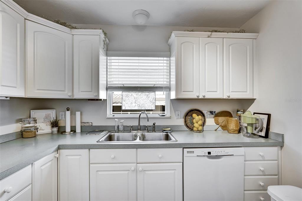 10315 Cortez Road West, Unit 19H Bradenton, FL 34210 - Photo 14 of 47 a kitchen with stainless steel appliances granite countertop white cabinets a sink and dishwasher