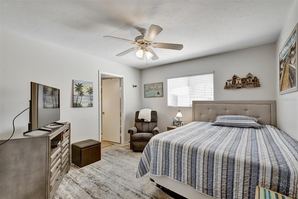 10315 Cortez Road West, Unit 19H Bradenton, FL 34210 - Photo 18 of 47 a bedroom with a bed and wooden floor