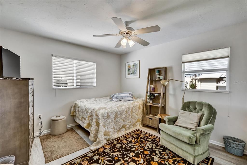 10315 Cortez Road West, Unit 19H Bradenton, FL 34210 - Photo 21 of 47 a bedroom with a bed and ceiling fan