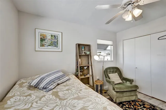 a bedroom with a bed and chair