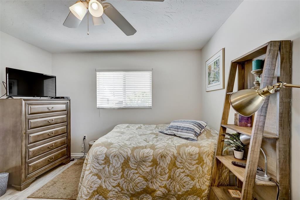 10315 Cortez Road West, Unit 19H Bradenton, FL 34210 - Photo 23 of 47 a bedroom with a bed and a flat screen tv