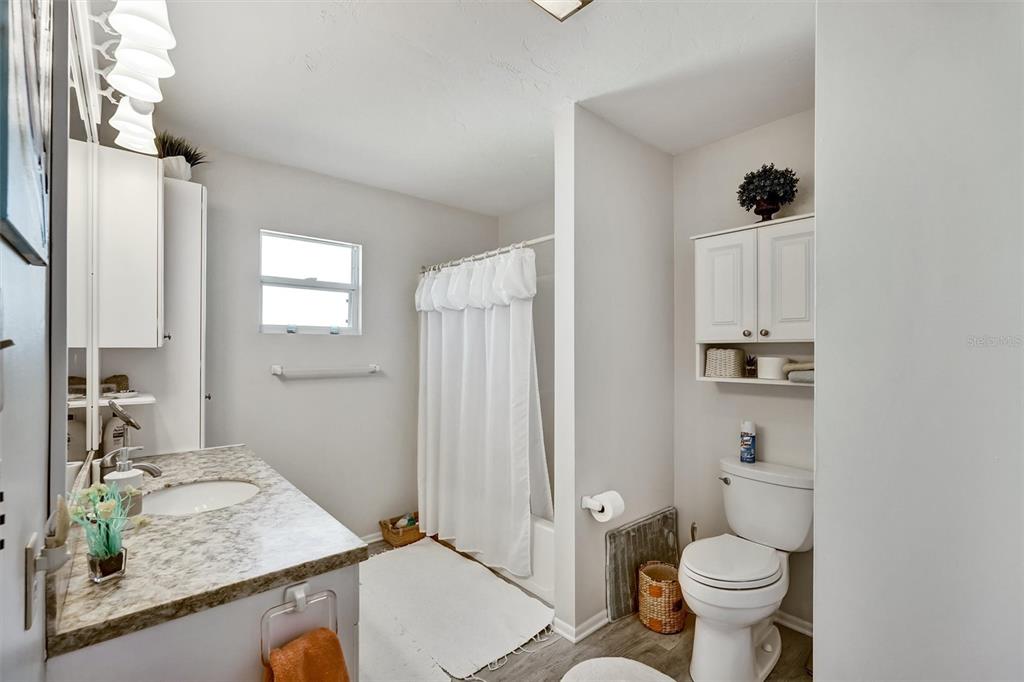 10315 Cortez Road West, Unit 19H Bradenton, FL 34210 - Photo 24 of 47 a bathroom with a granite countertop sink toilet and shower