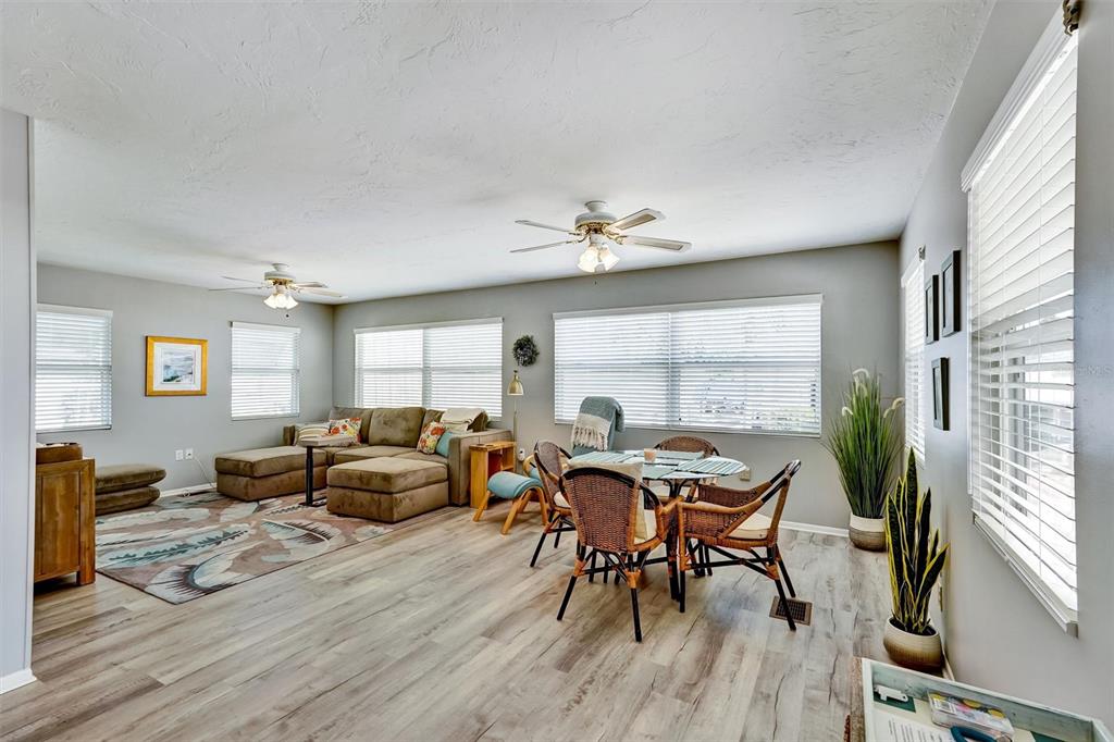 10315 Cortez Road West, Unit 19H Bradenton, FL 34210 - Photo 5 of 47 a view of a dining room with furniture window and wooden floor
