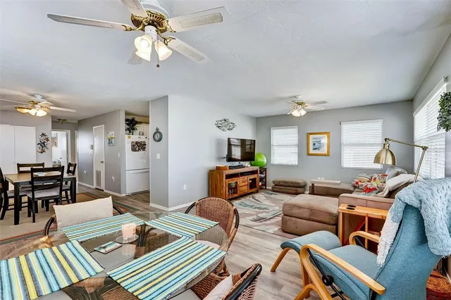 a living room with furniture a rug and a chandelier