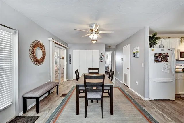 a dining room with furniture a rug and a chandelier