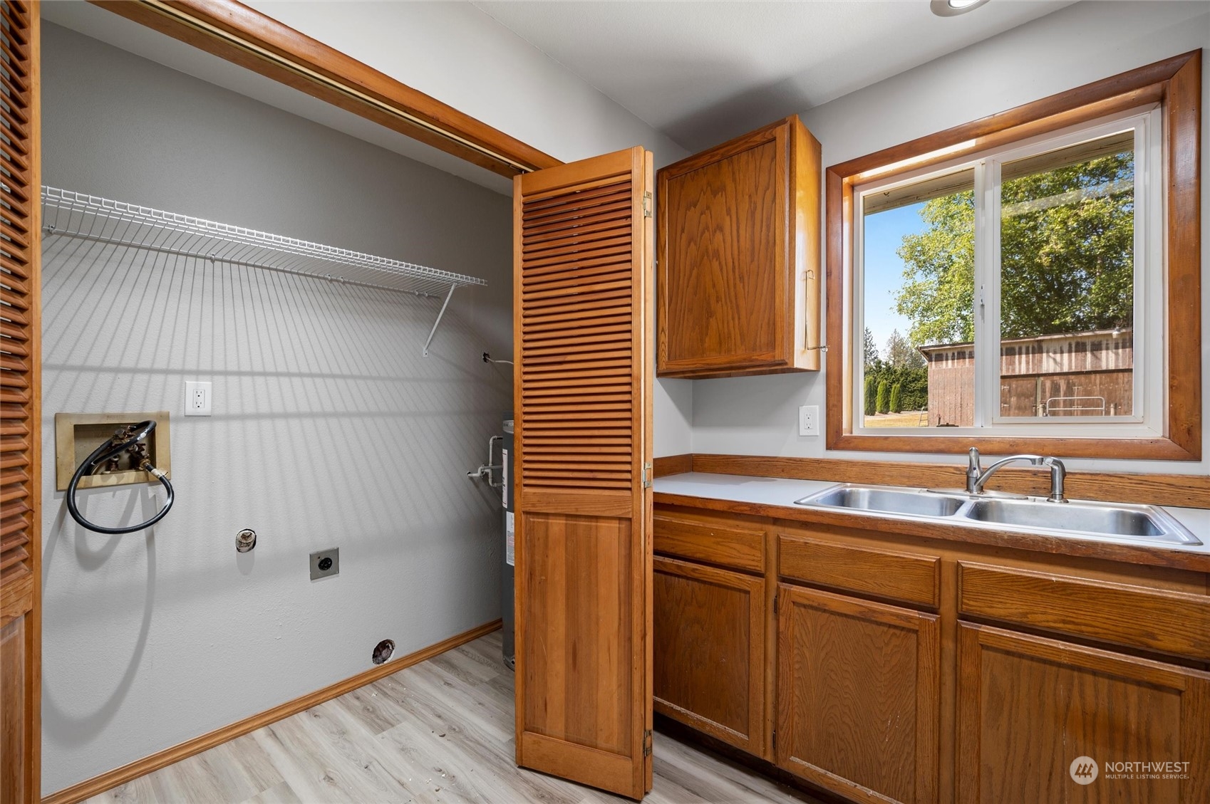 8879 Stein Road Custer, WA 98240 - Photo 11 of 22 a kitchen with a sink and wooden floor