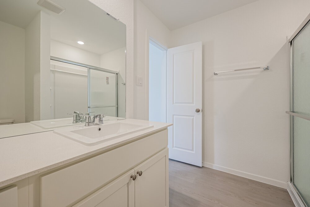 621 Craven Street Conroe, TX 77316 - Photo 10 of 16 a bathroom with a sink and a mirror
