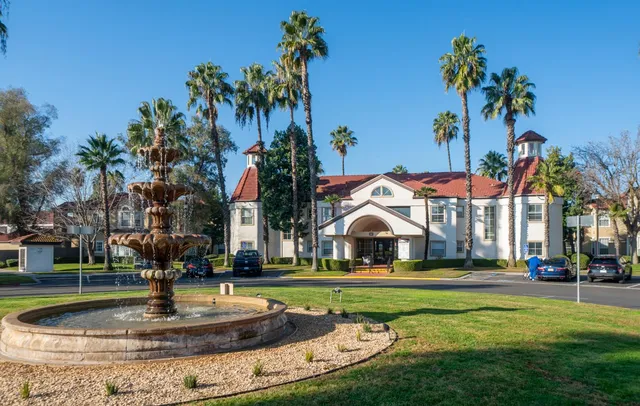 a view of a fountain in front of a building with a fountain