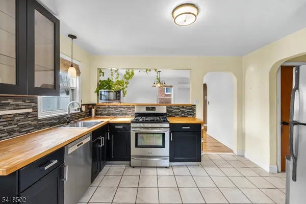 a kitchen with a sink and a stove top oven