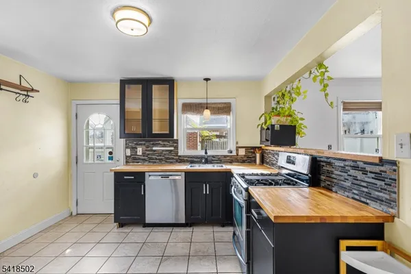 a kitchen with a stove a refrigerator and cabinets