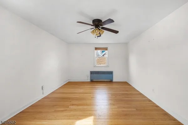 a view of an empty room and wooden floor