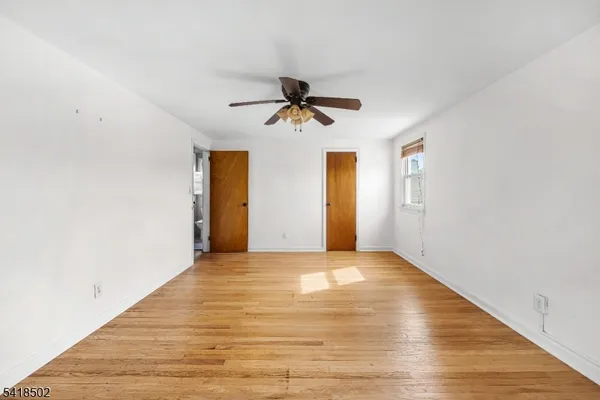a view of an empty room and wooden floor