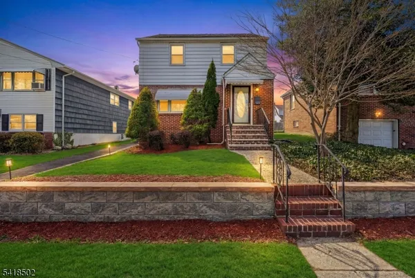 a front view of a house with a yard and outdoor seating