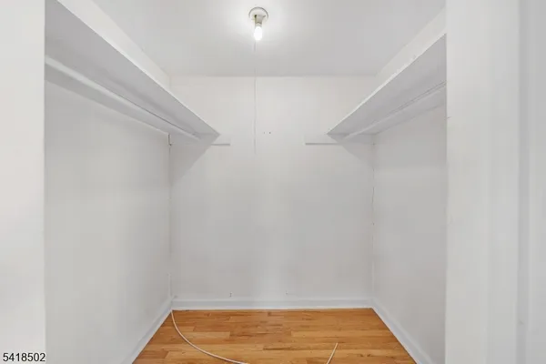 a view of a room with wooden floor and window