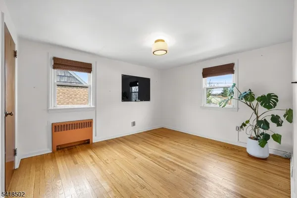 a view of a room with wooden floor and cabinet