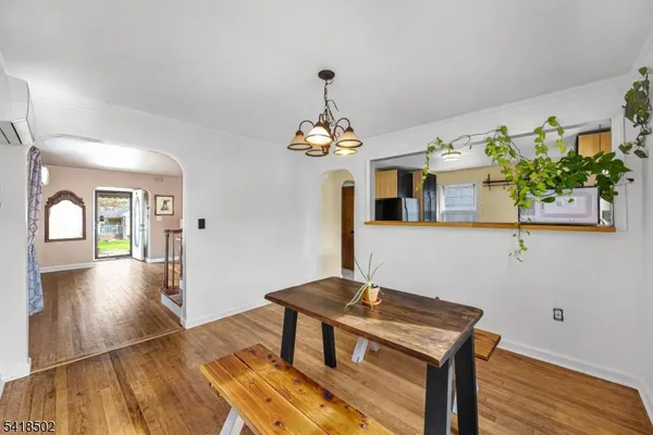 a workspace room with wooden floor table and chair