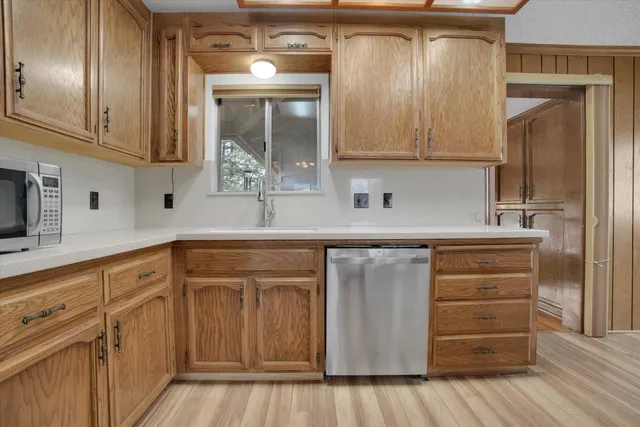 a kitchen with cabinets and a wooden floor