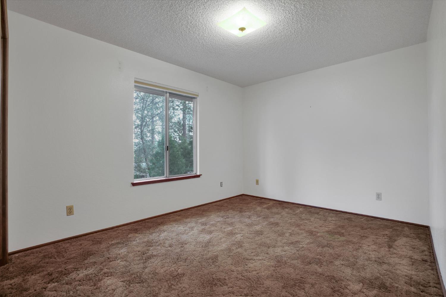 12066 Breckenridge Road Groveland, CA 95321 - Photo 15 of 41 an empty room with a window